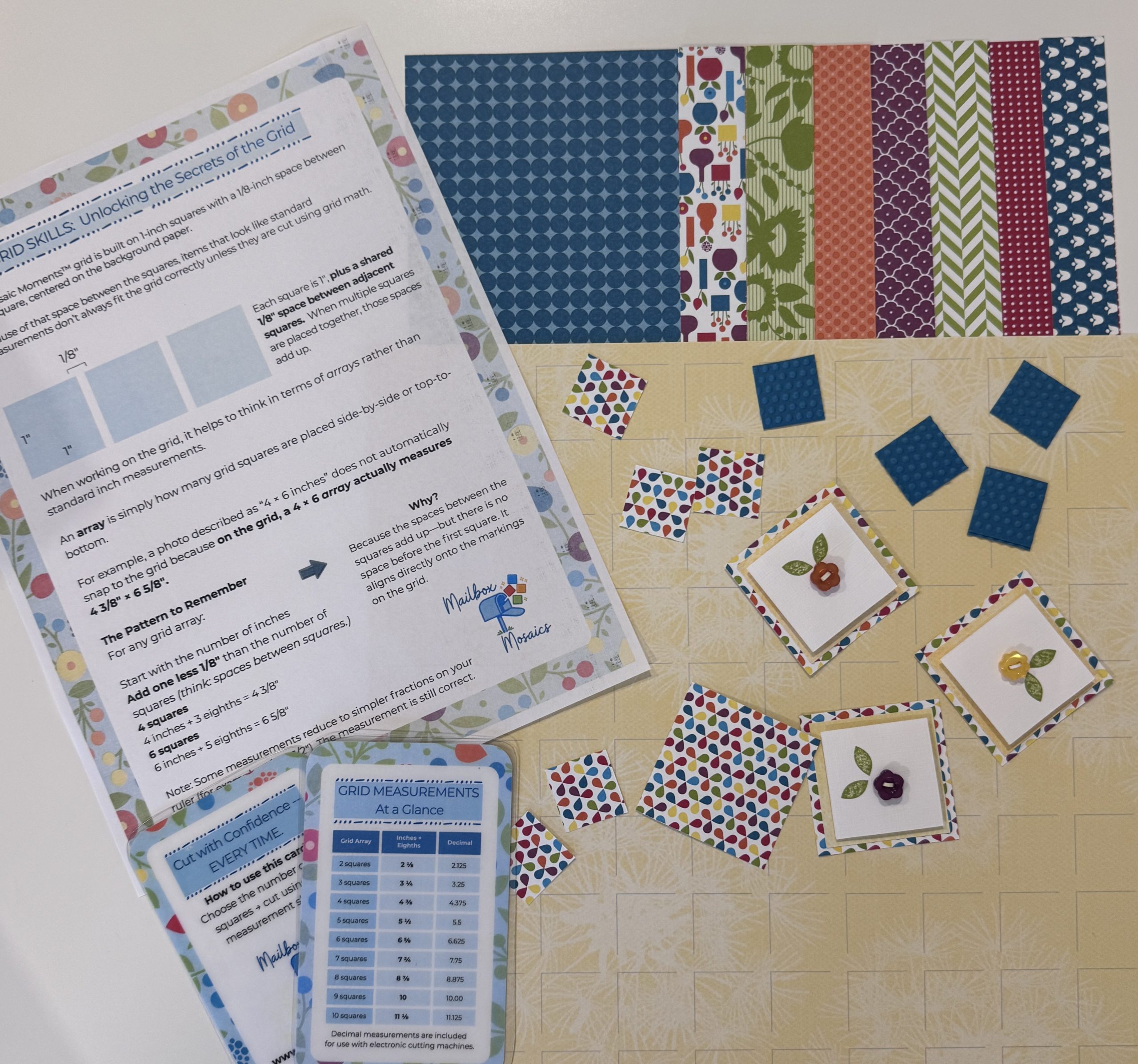 Colorful grid paper, instructions, and embellishments prepared for a beginner class